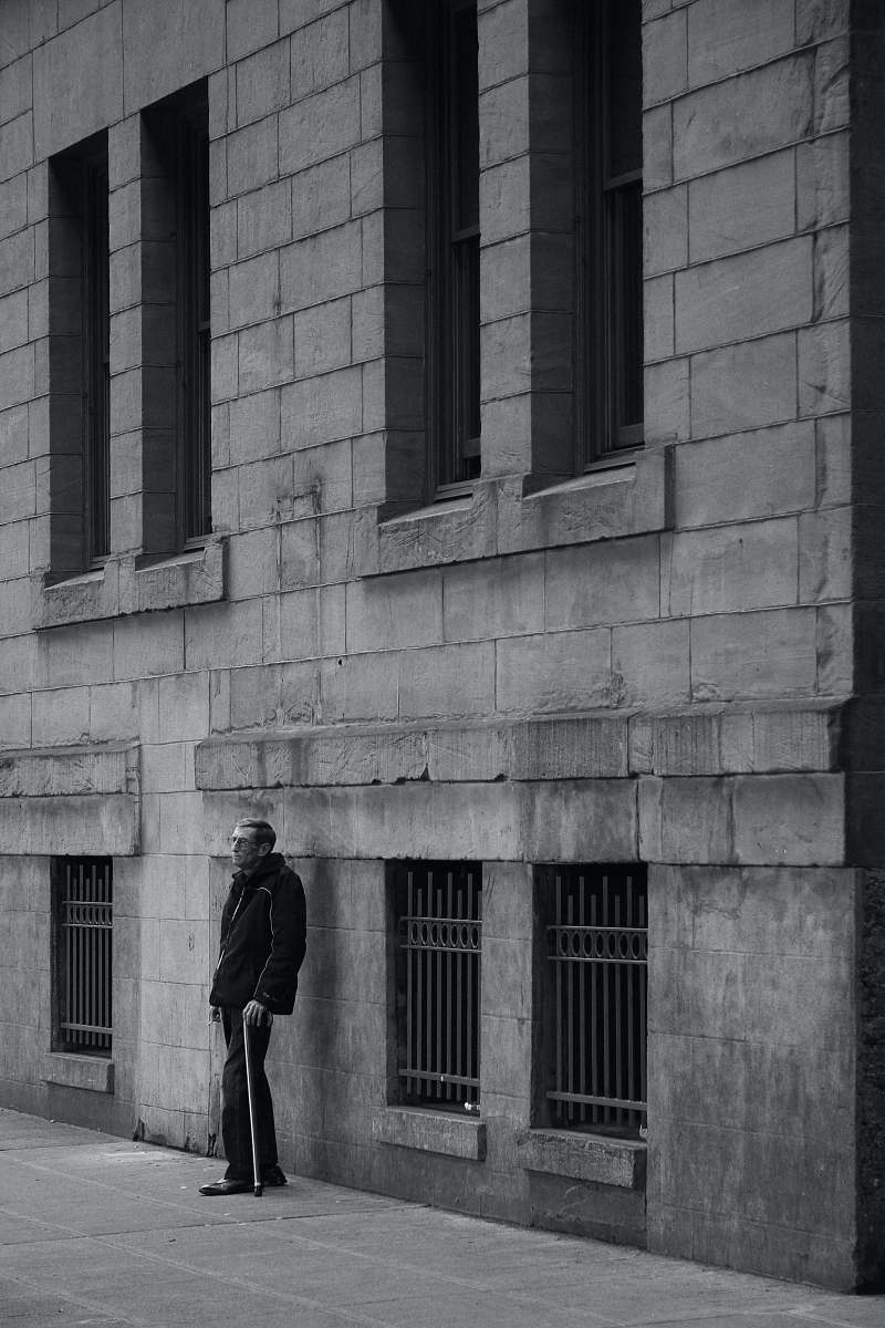 black-and-white man standing near a wall seattle